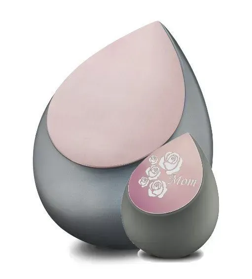 Three teardrop-shaped cosmetic containers in pink and gray, one with rose design and “Home” text.