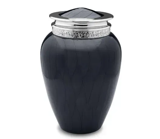 Dark blue decorative funeral urn with silver lid on white background
