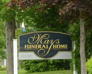 A dark, arched sign reading 