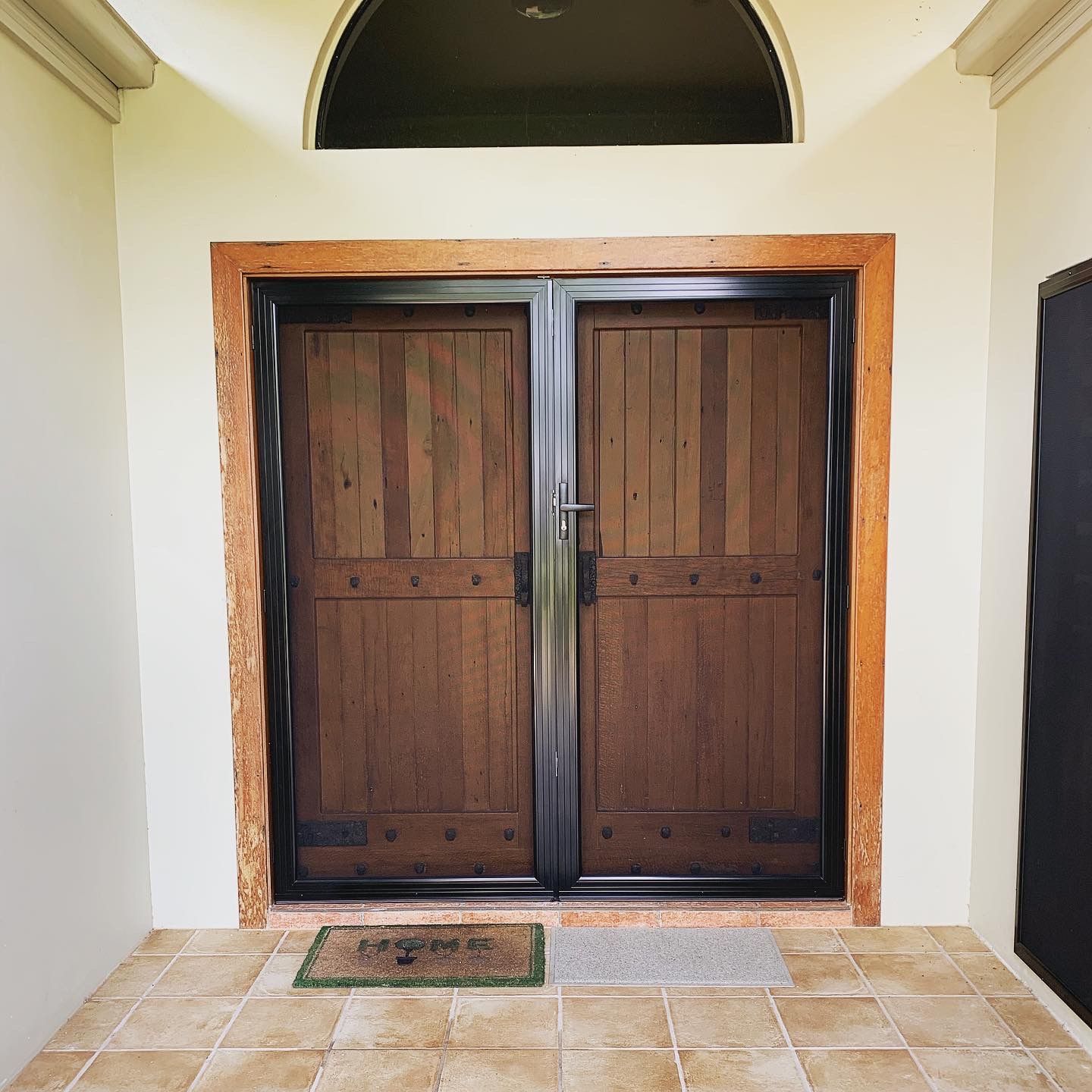 A door with a welcome mat in front of it