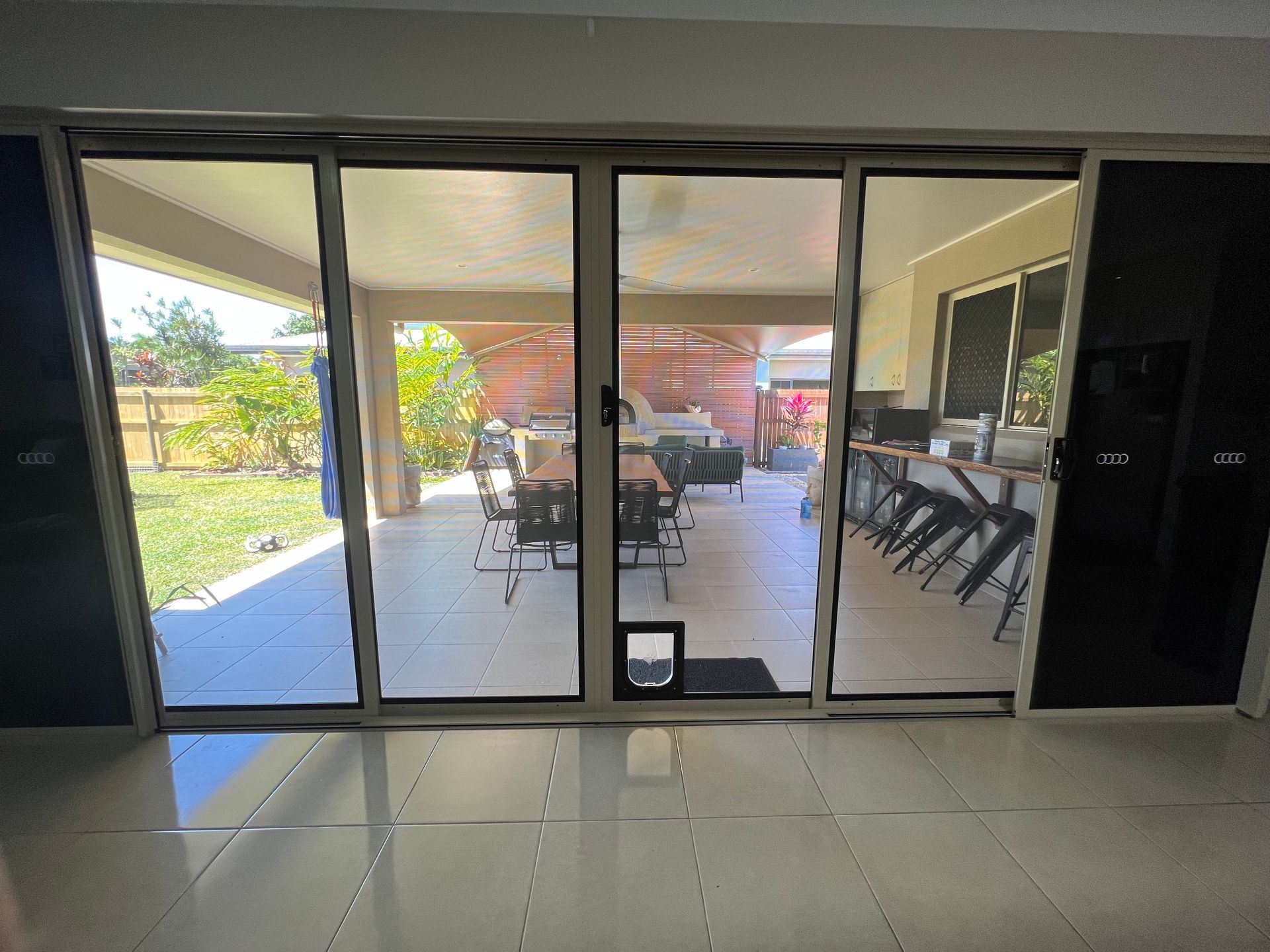A room with a sliding glass door leading to a patio.