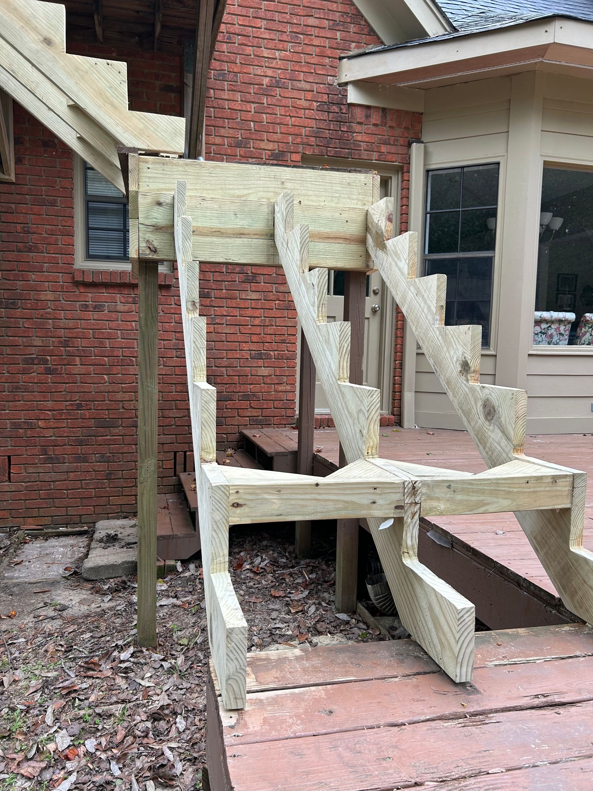 A large house with a lot of windows and a garage on a rainy day.