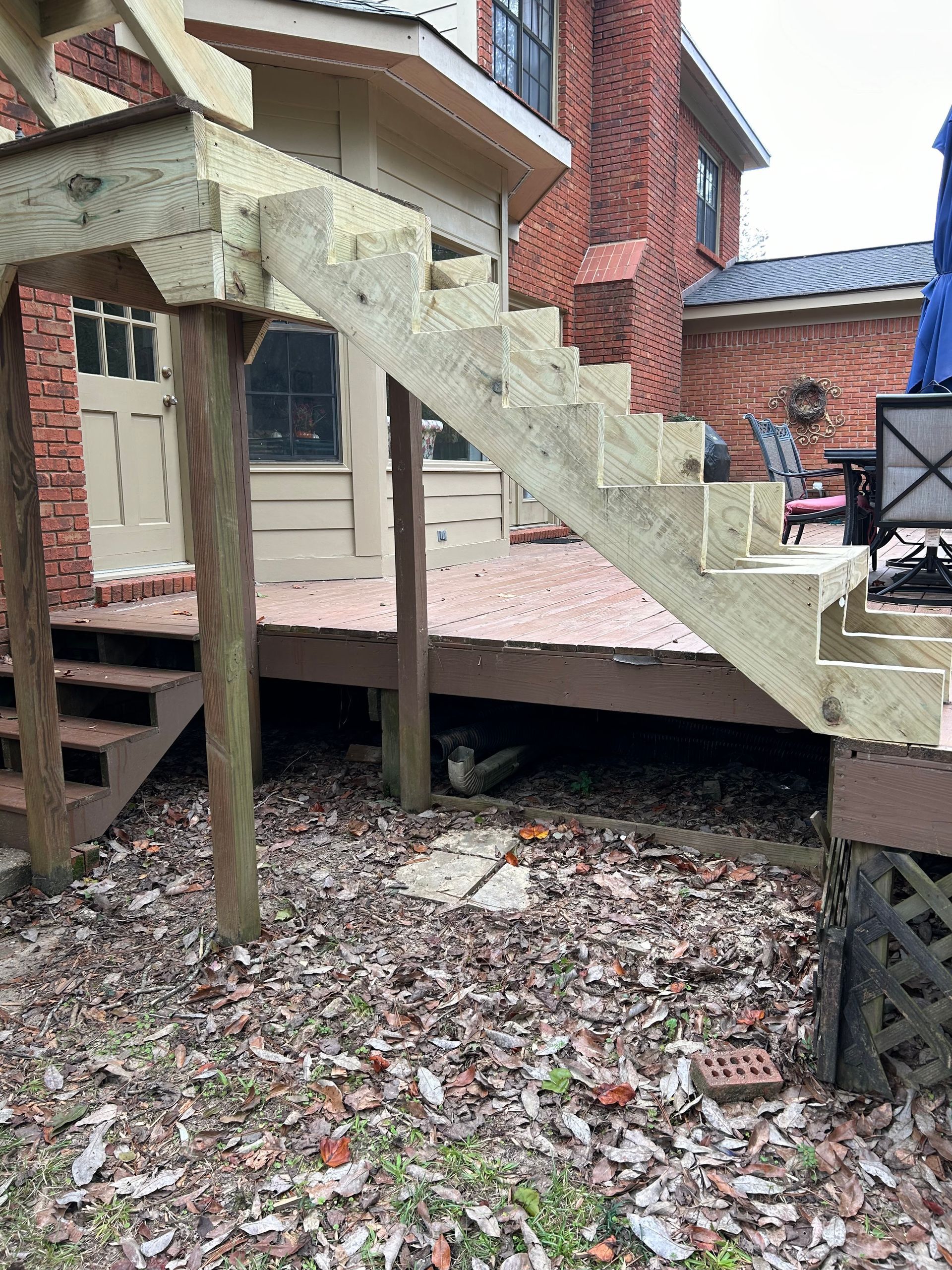 A large house with a lot of windows and a garage on a rainy day.