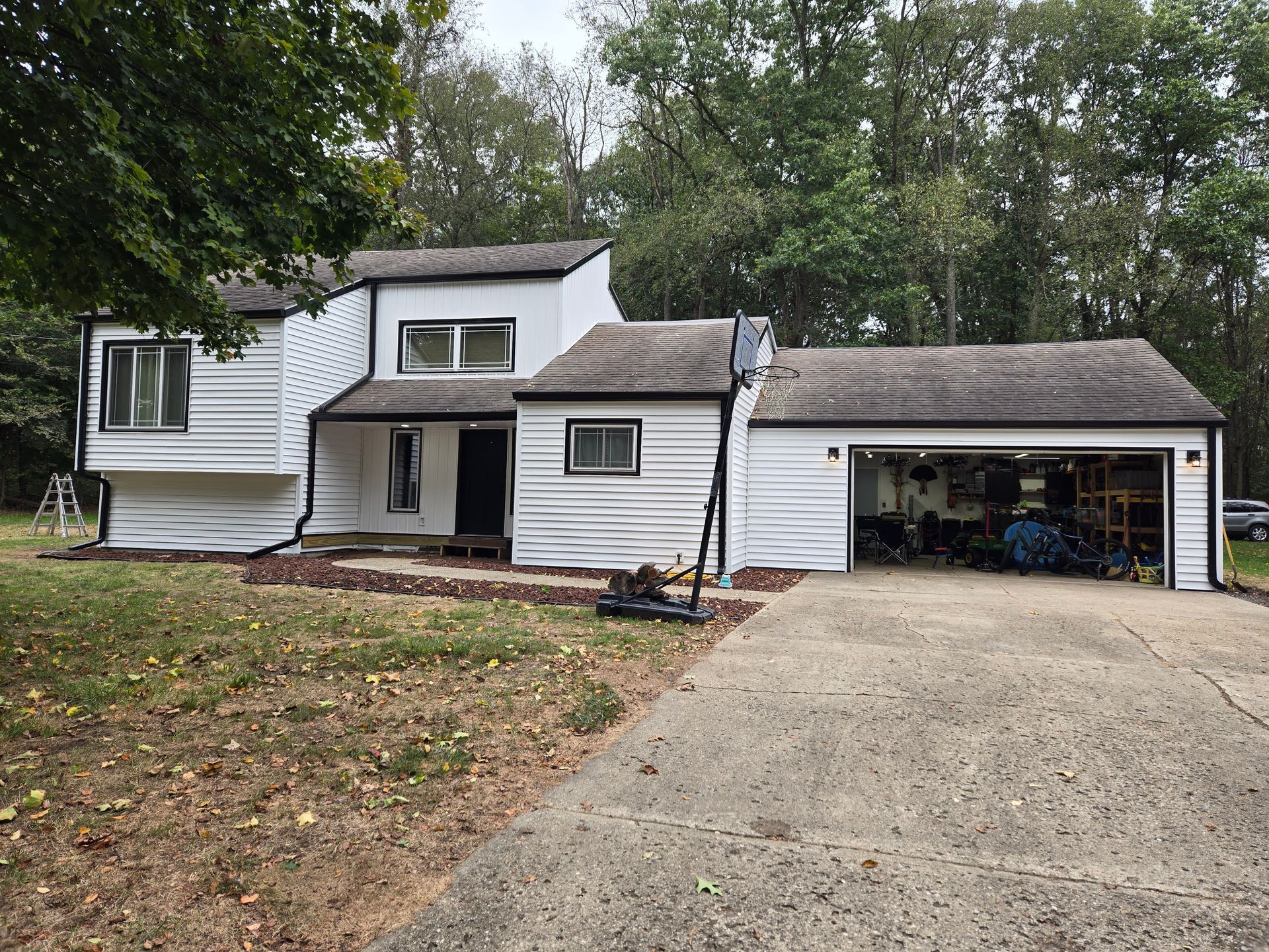 A large white house with a garage and a driveway.