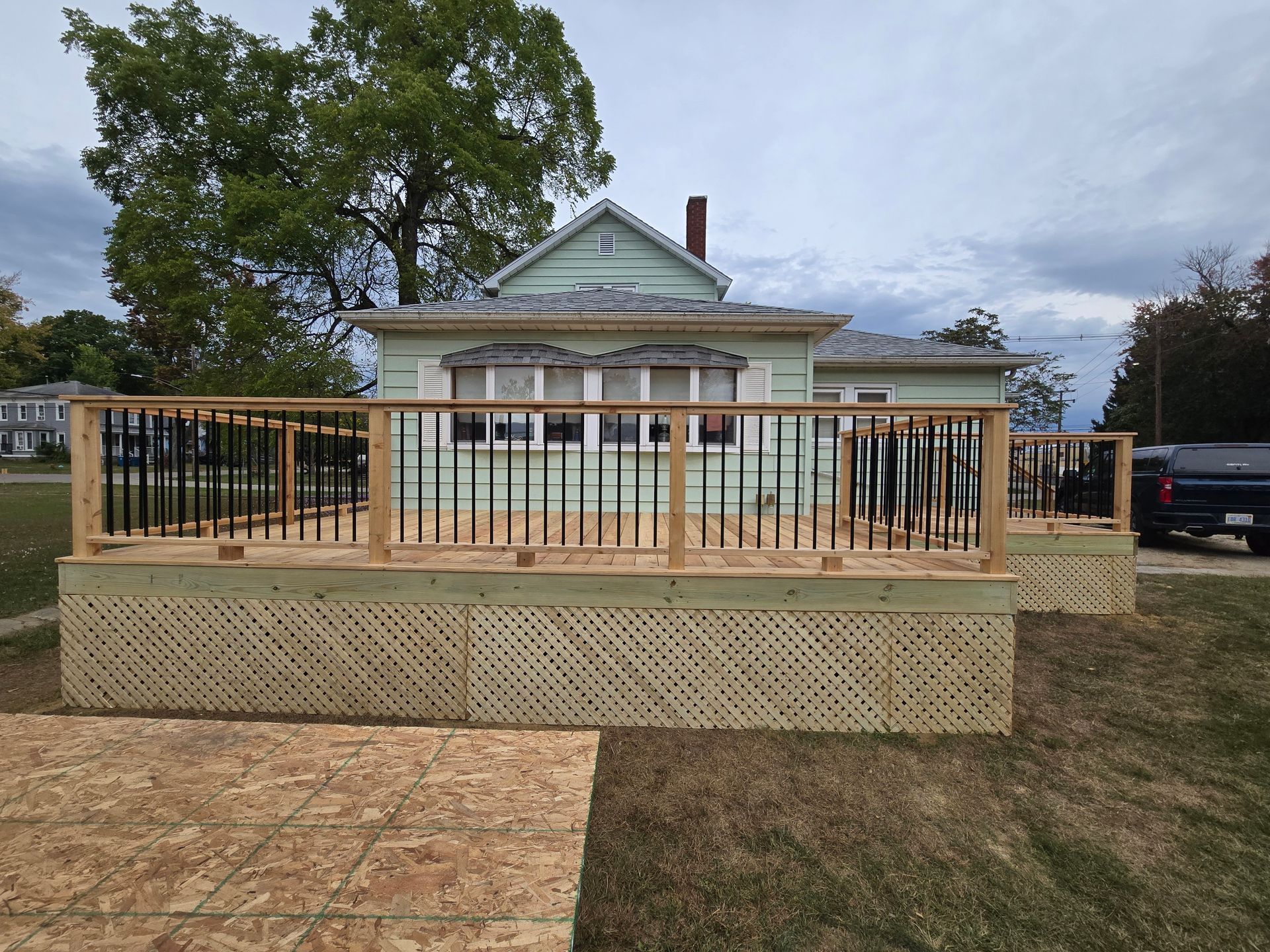 A house with a wooden deck in front of it