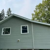 A house with a lot of windows and trees in the background.