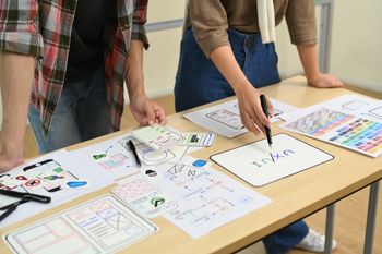 A group of people are working on a project at a table.