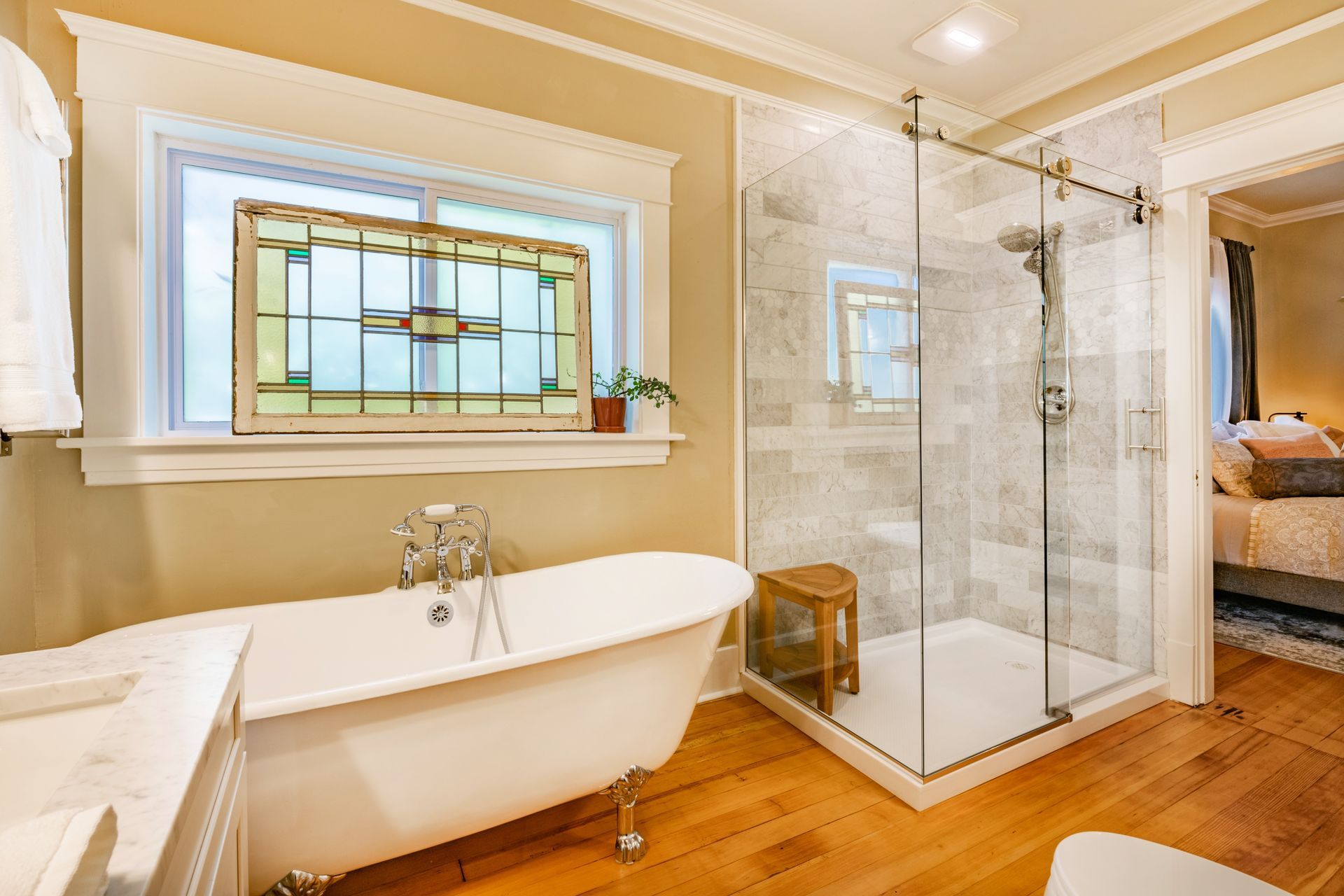 A bathroom with a tub and a walk in shower.