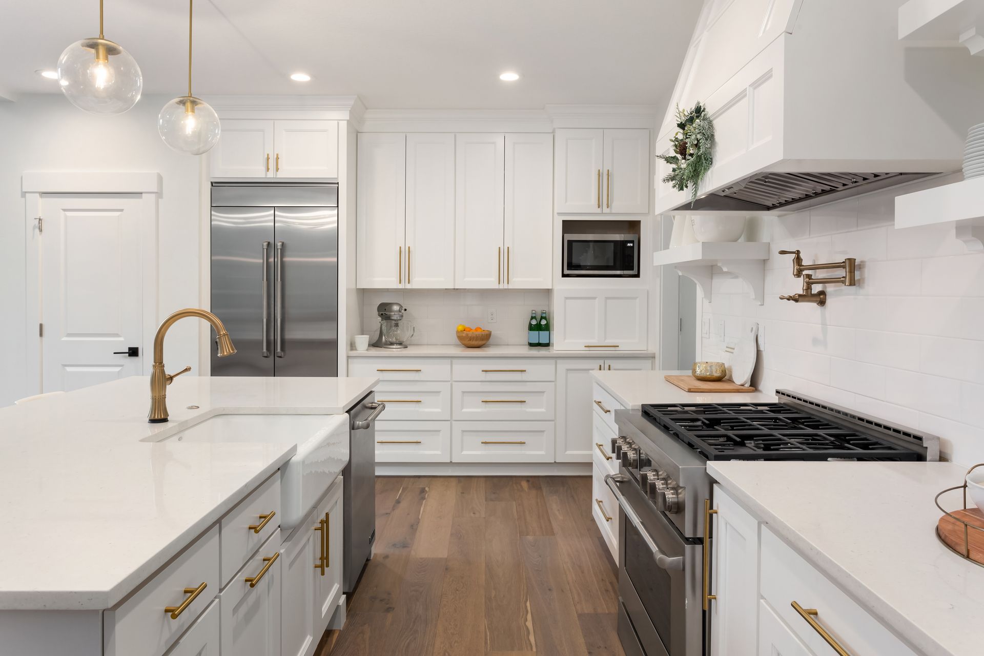 A kitchen with white cabinets and stainless steel appliances.