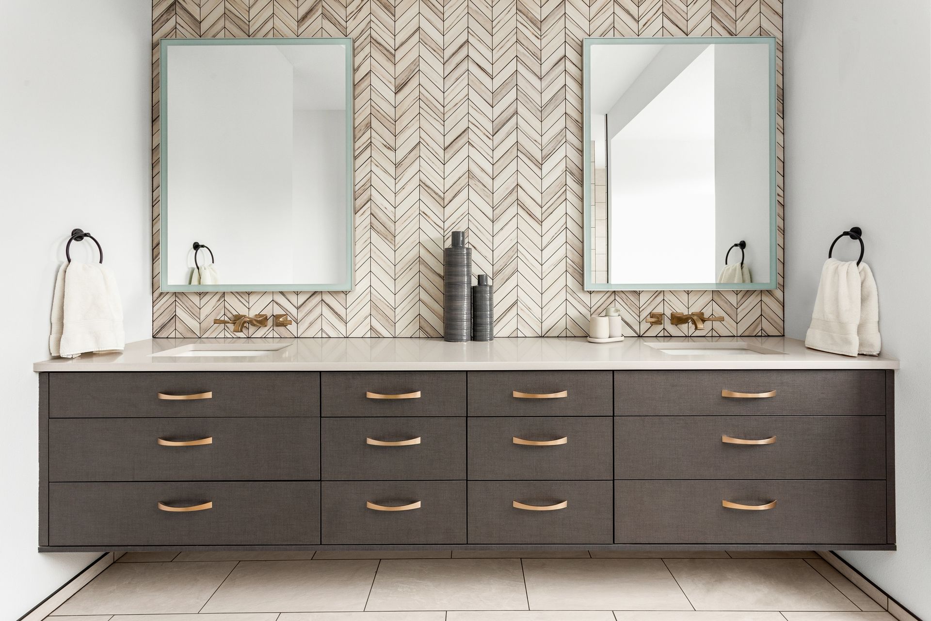 A bathroom with two sinks and two mirrors.