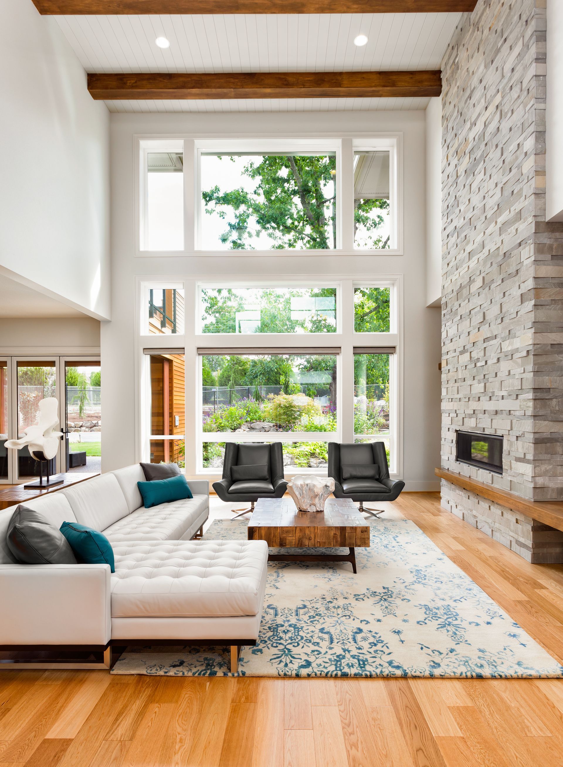 A living room with a couch , chairs , coffee table and fireplace.