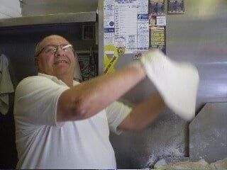 Pizza Restaurant — Pizza Maker Tossing the Pizza Dough in Pittsburgh & McMurray, PA