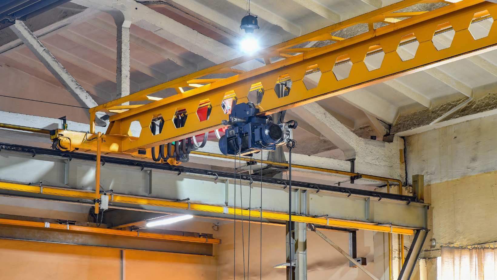 A crane is hanging from the ceiling of a building.