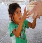 Young Guatemalan girl gets a bowl of nutritious soup