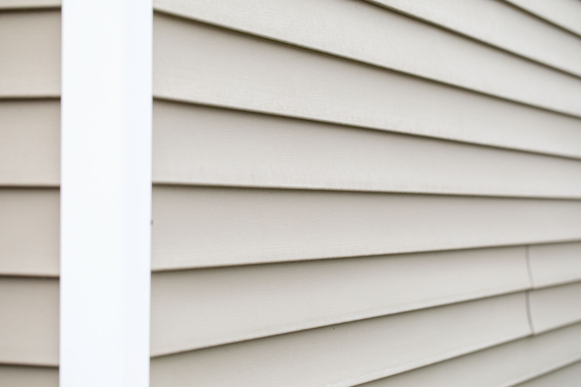 A close up of a white siding on a house