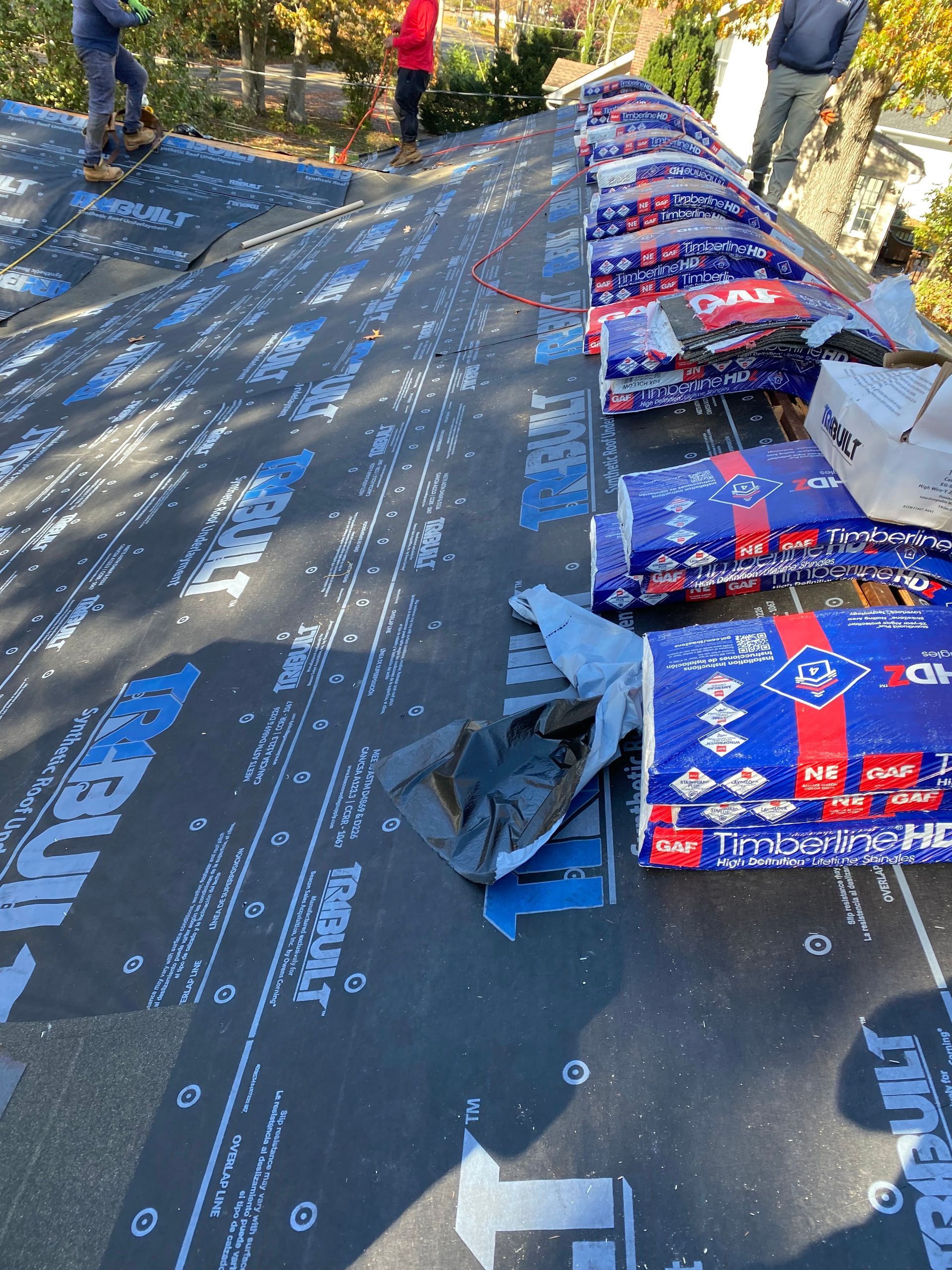 A group of people are working on a roof.