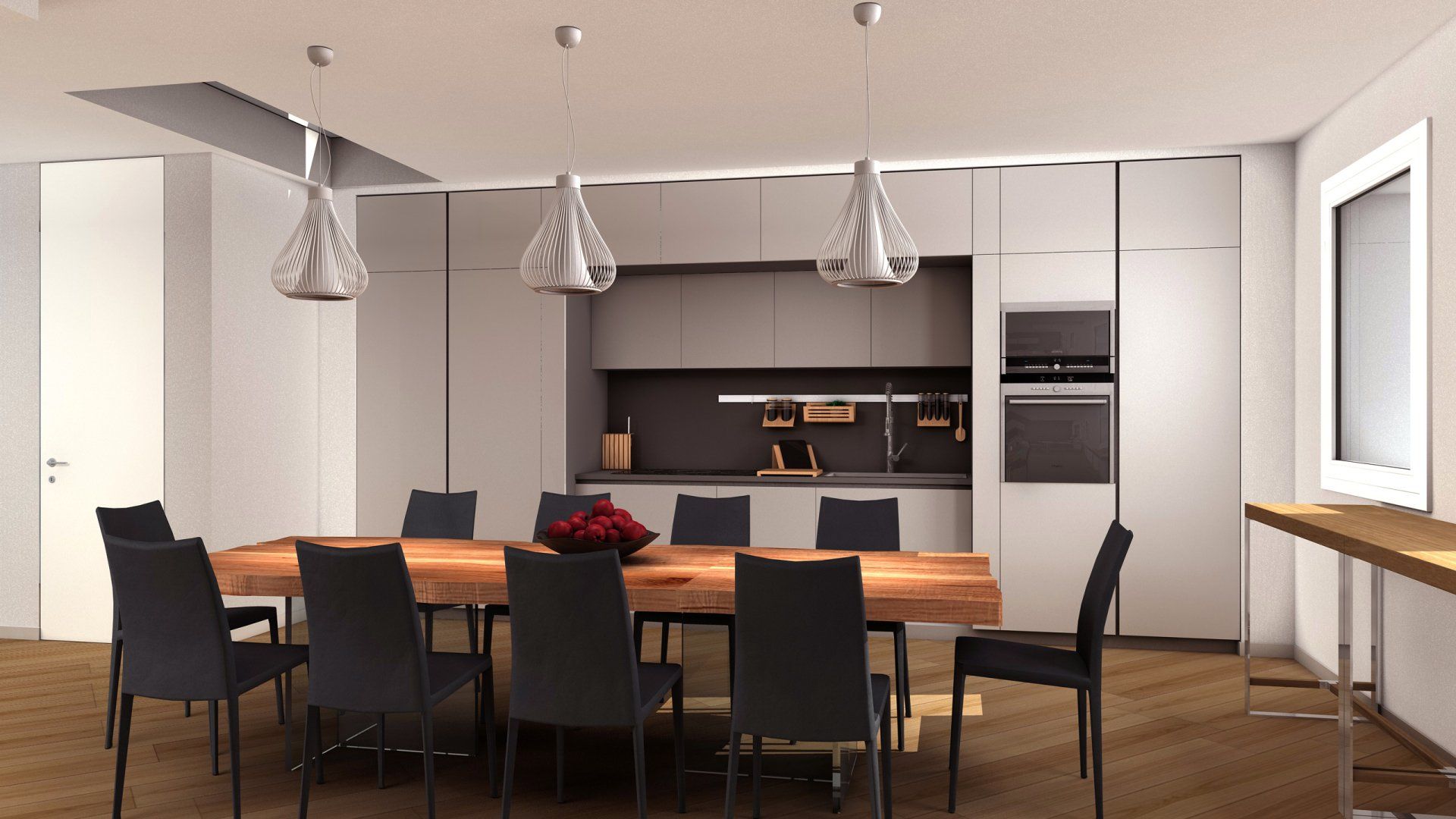 Una sala da pranzo con tavolo e sedie e sullo sfondo la cucina
