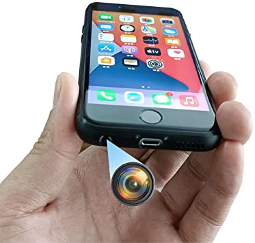 A person is holding a cell phone with a camera attached to it.