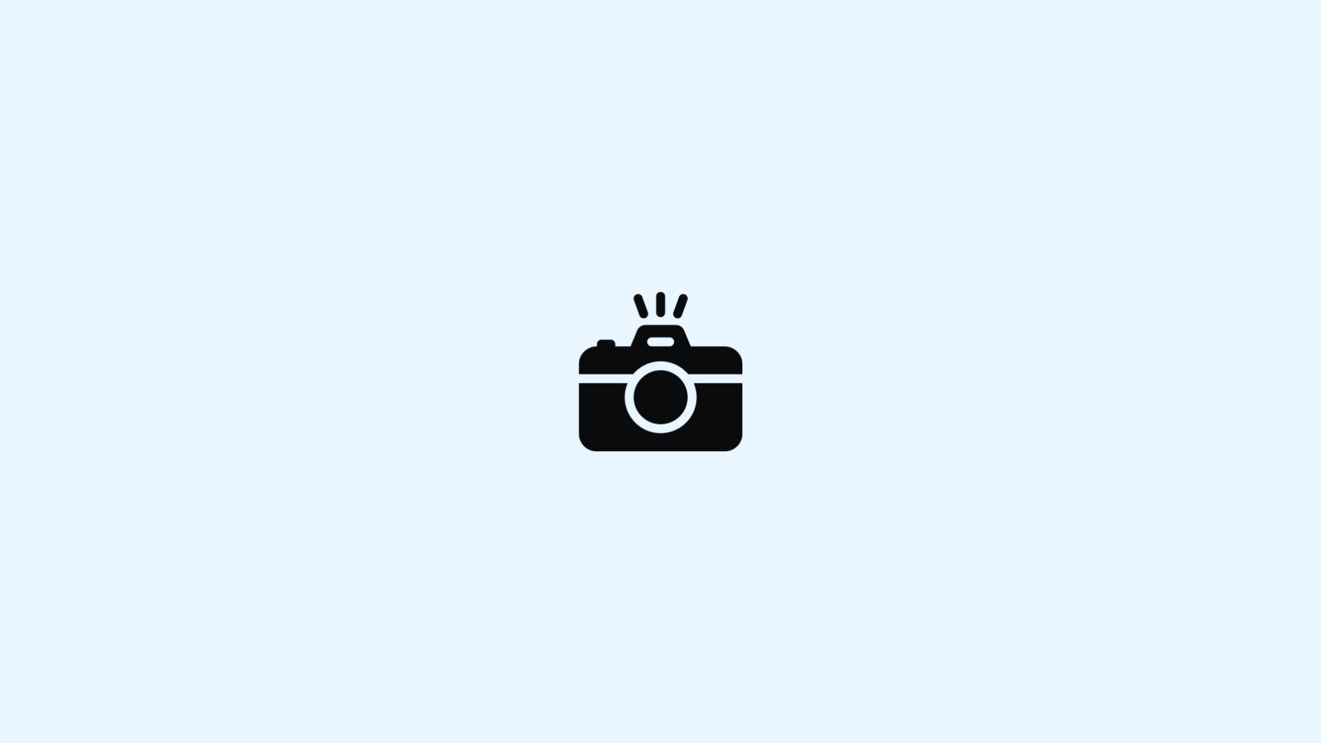 Black camera icon with flash marks on a pale blue background