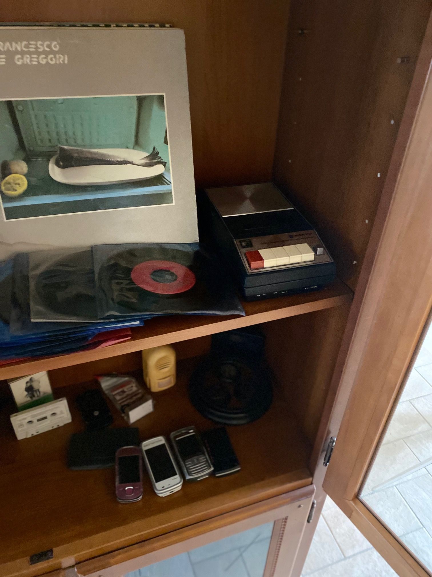 A shelf with a photo of a cat on top.