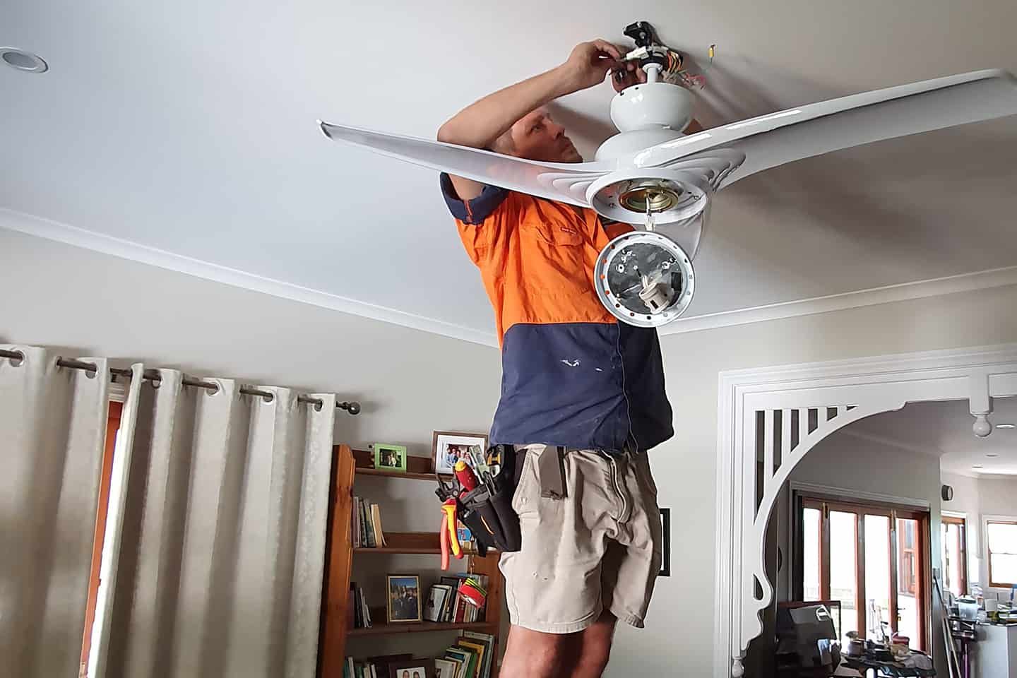 Man Installing fan — Electrician in Mount Louisa QLD
