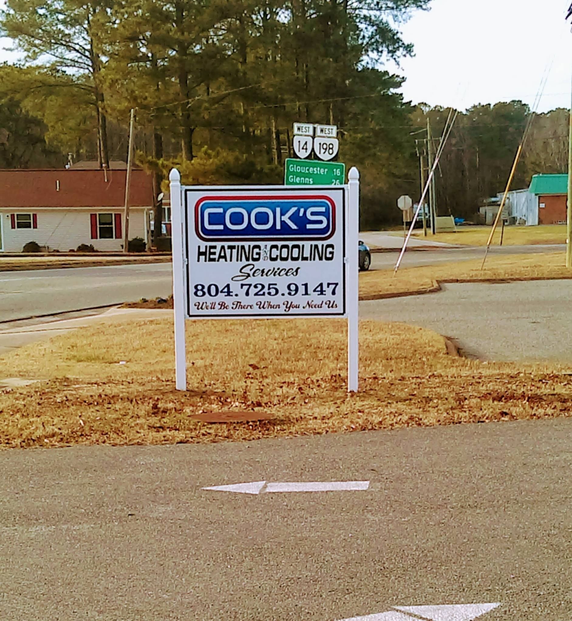 A cook 's heating and cooling sign on the side of the road
