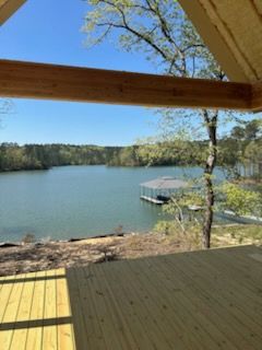 A view of a lake from a wooden deck