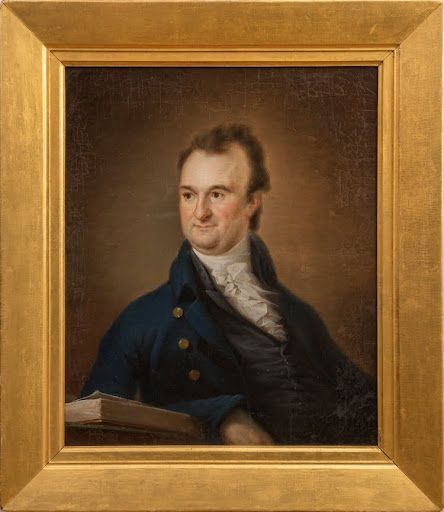 Portrait of a man in a blue coat, looking to the side, leaning on a book.