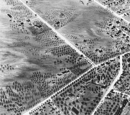 Aerial view of a town with roads, buildings, and trees; likely historical map illustration.