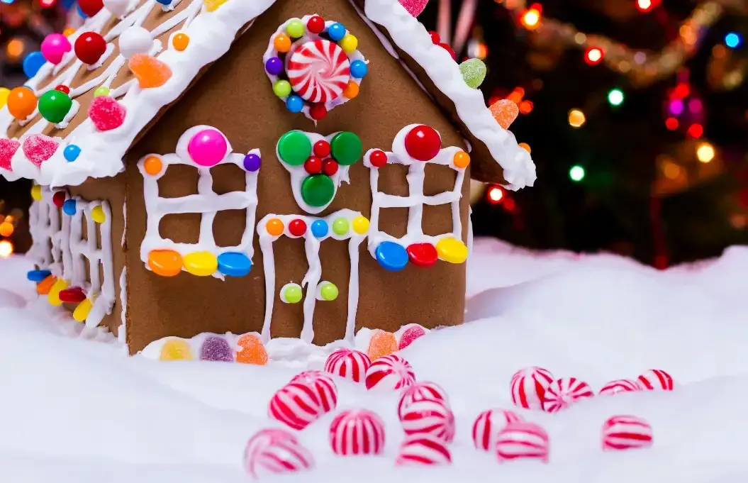 Tea setting on a table, with cups, teapot, and napkins. A window and chairs are in the background.