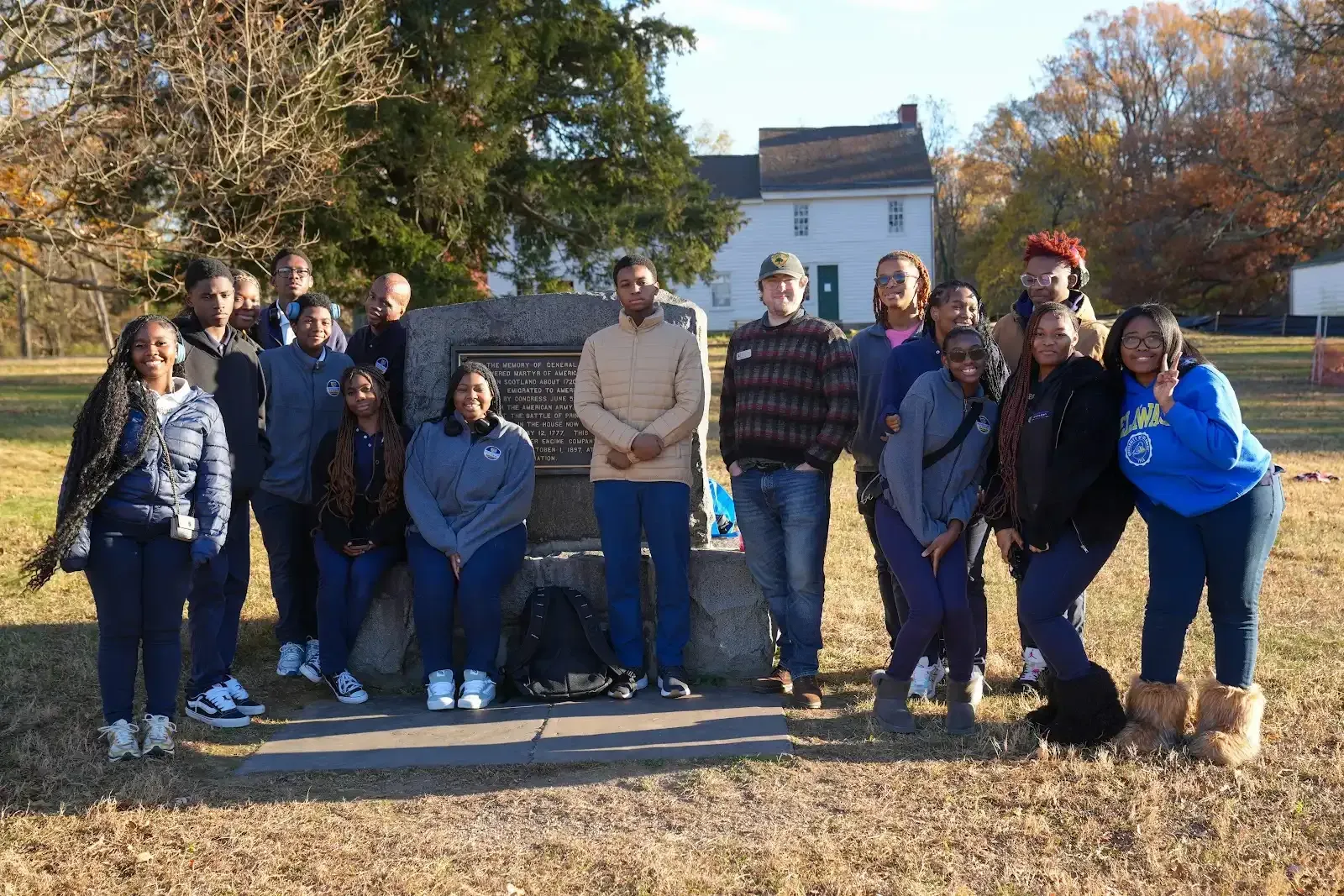 Tea setting on a table, with cups, teapot, and napkins. A window and chairs are in the background.