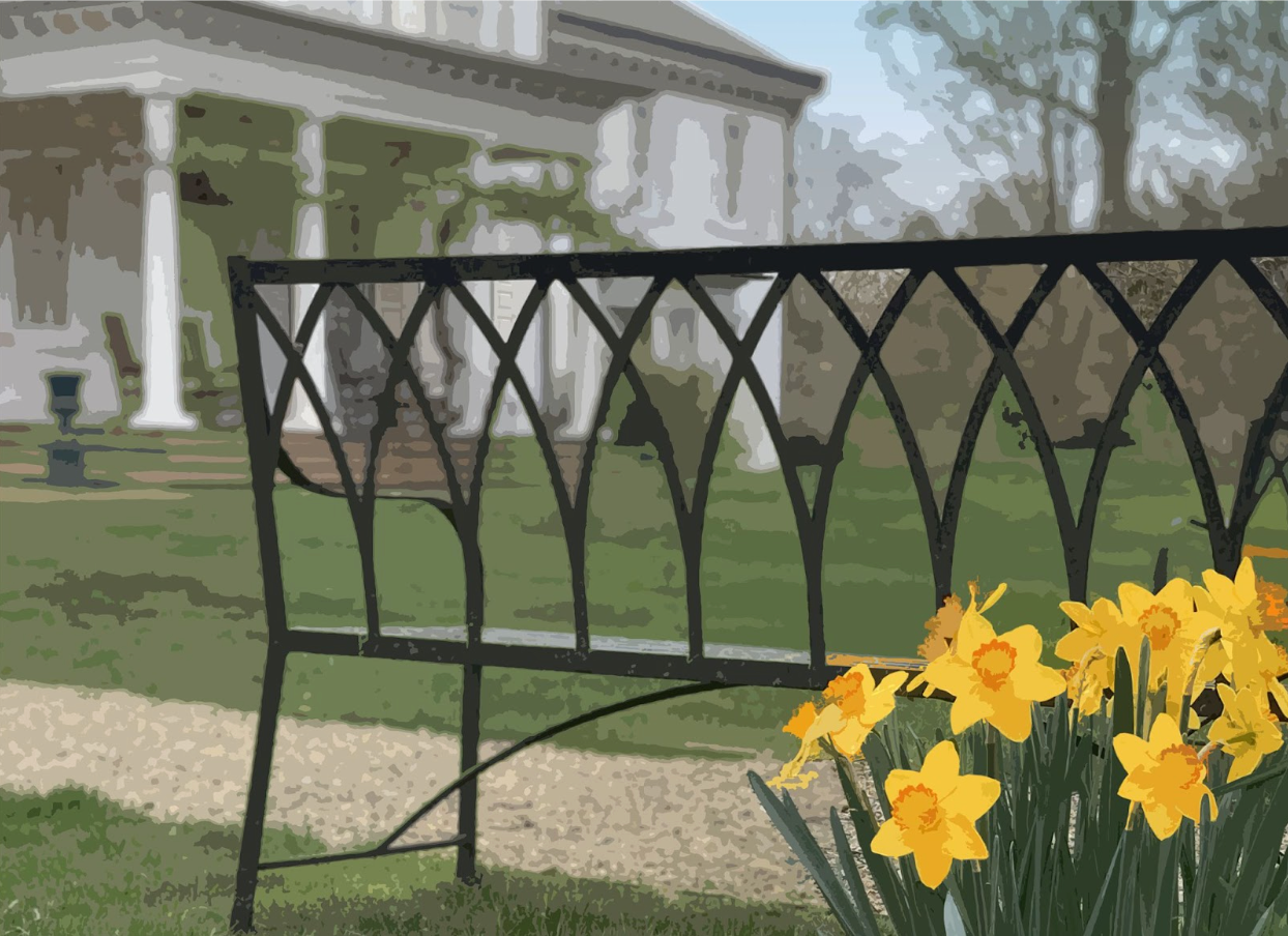 Tea setting on a table, with cups, teapot, and napkins. A window and chairs are in the background.