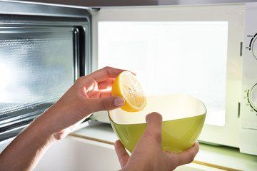 putting a bowl with lemon juice in a microwave