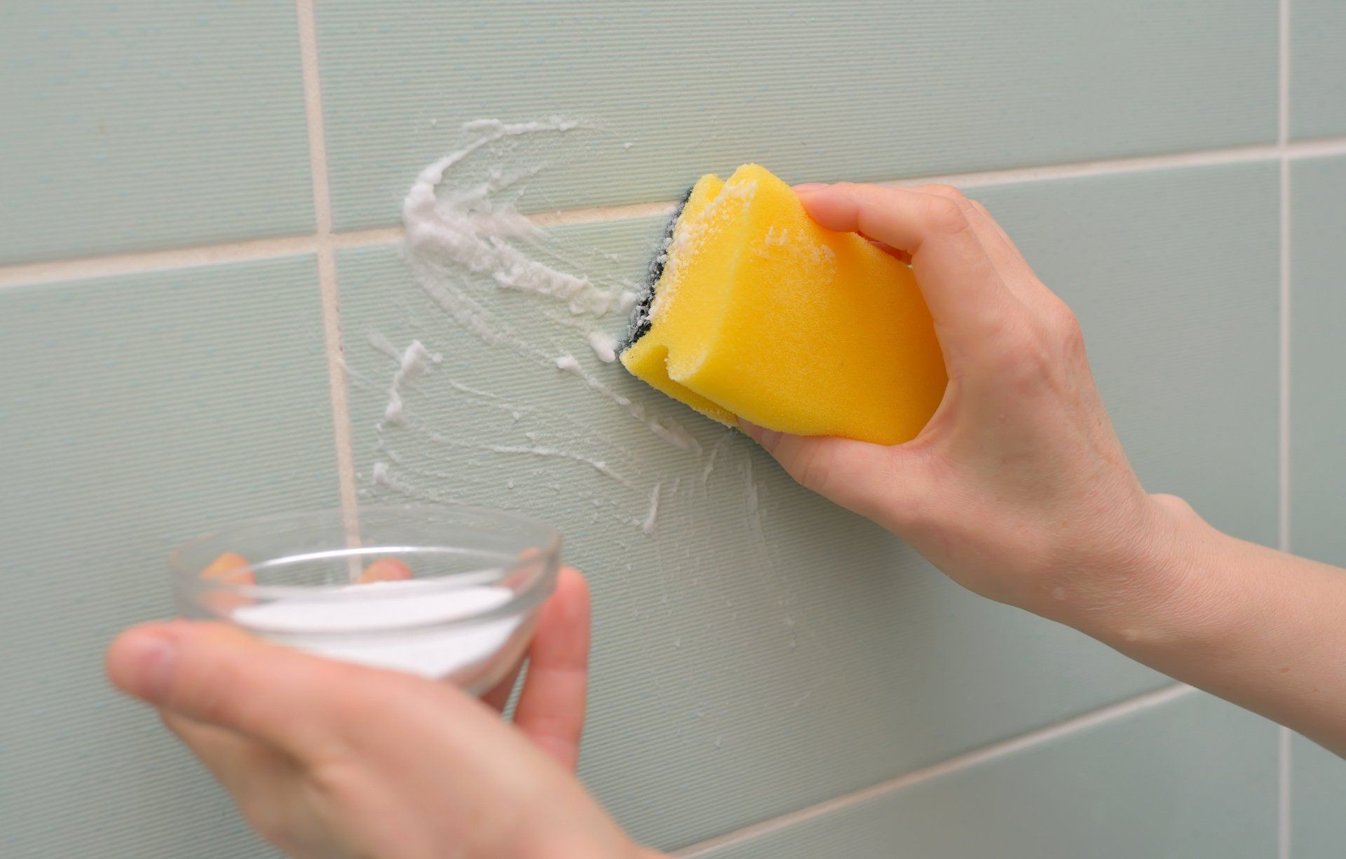 scrubbing bathroom walls with baking soda