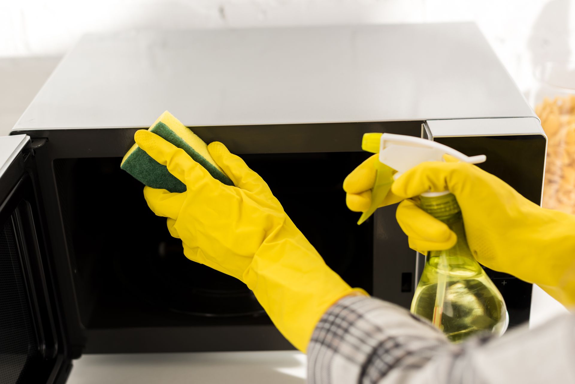 cleaning a table's surface with sponge