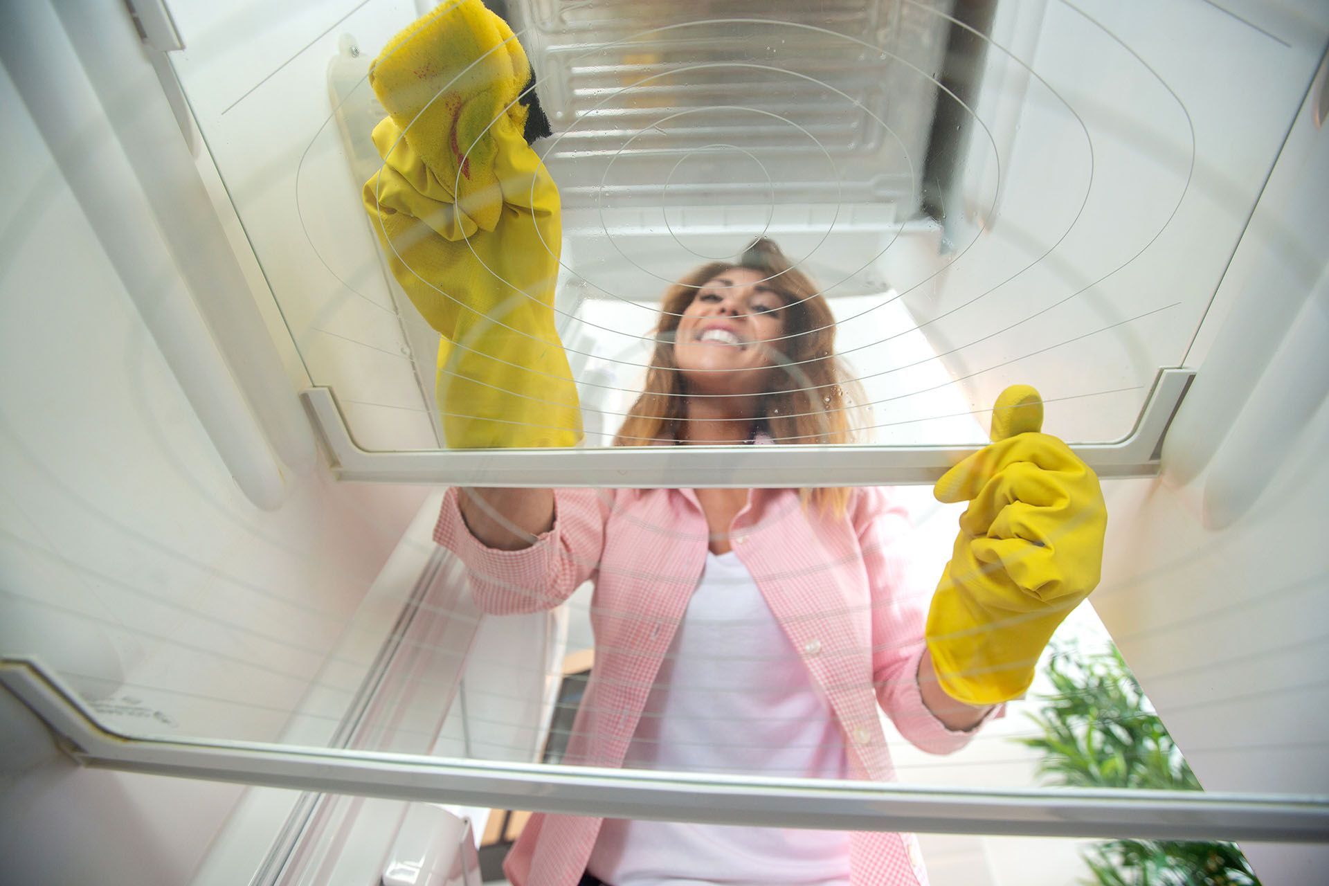 woman cleaning the fridge