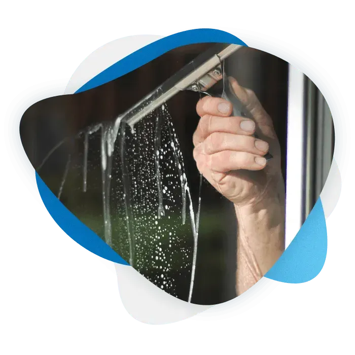 a squeegee being used to clean a window