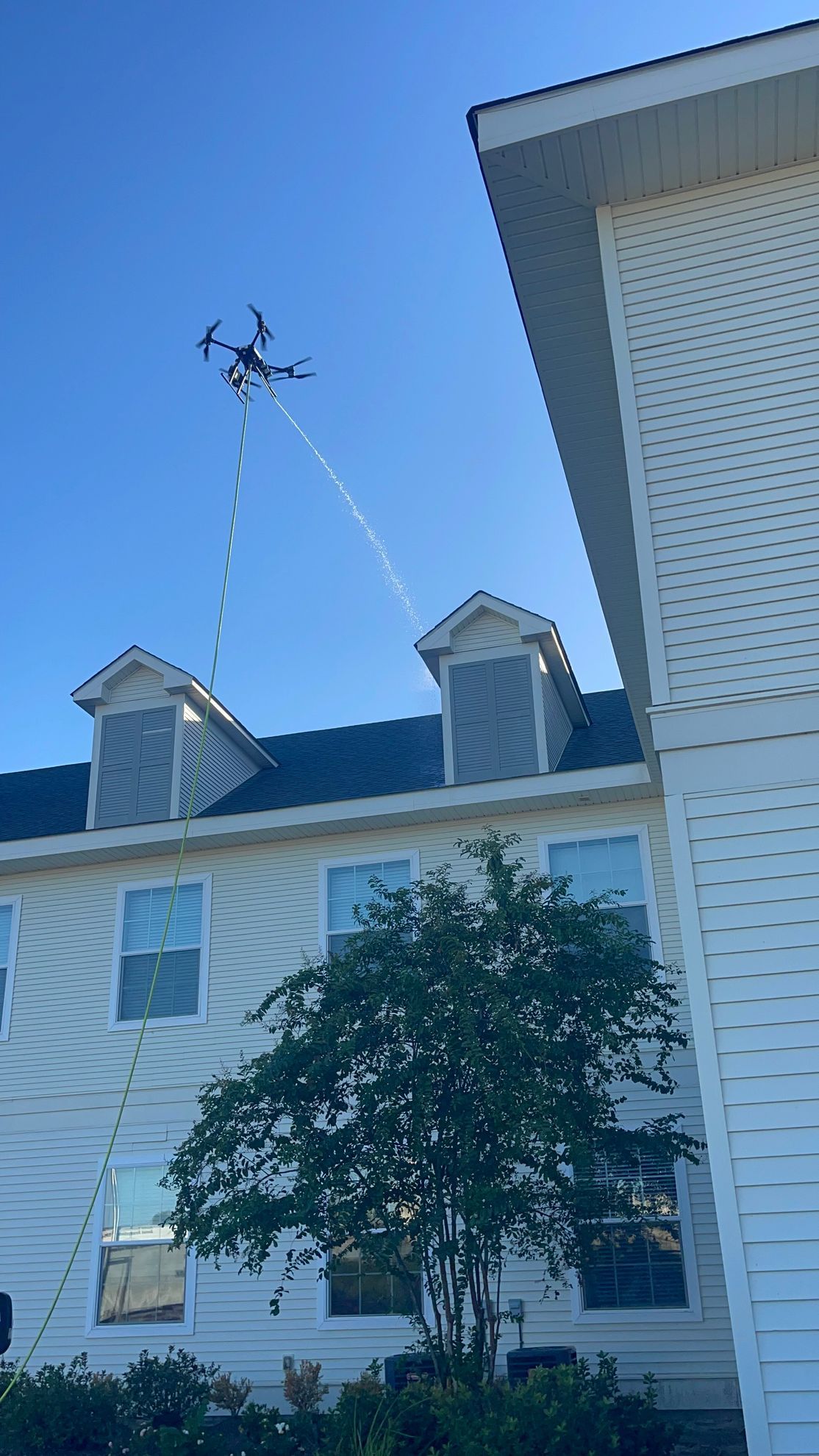 Pressure washing siding of house