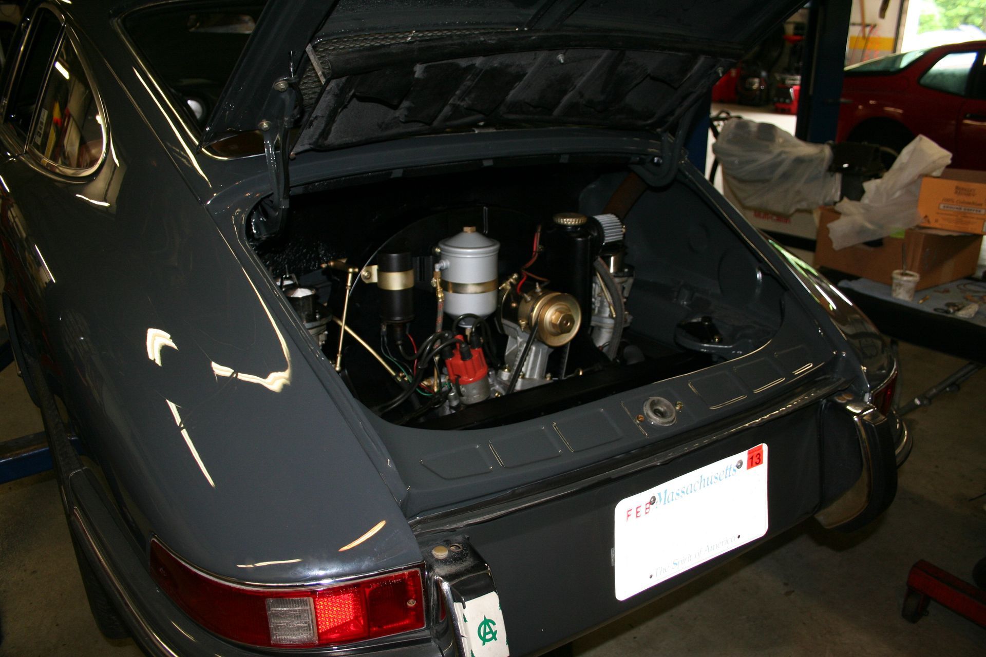 Gray Porsche with the engine compartment open, showcasing the engine. | Autobahn Performance Inc