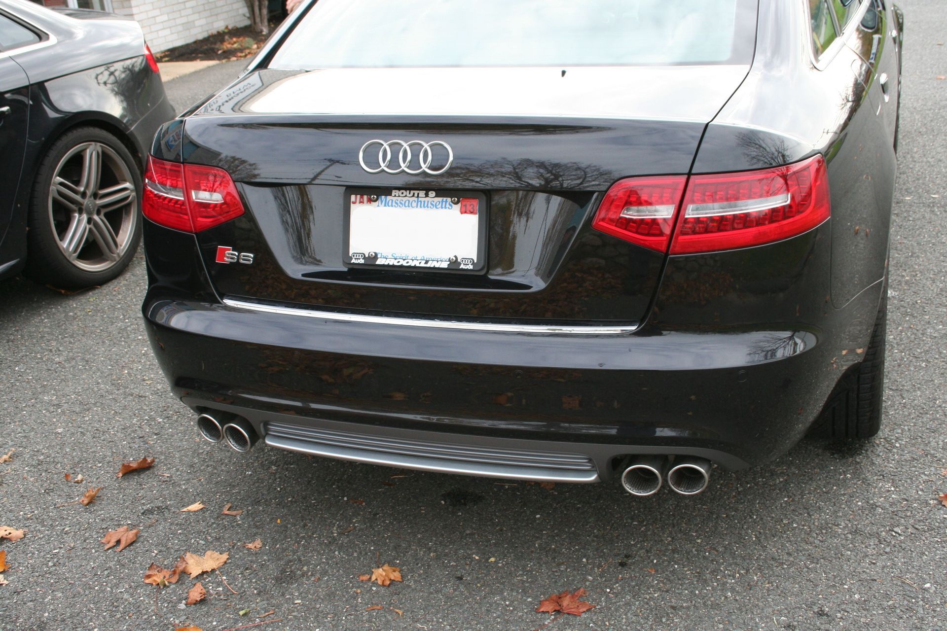 Black Audi S6 sedan, rear view, with dual exhaust and chrome trim. | Autobahn Performance Inc