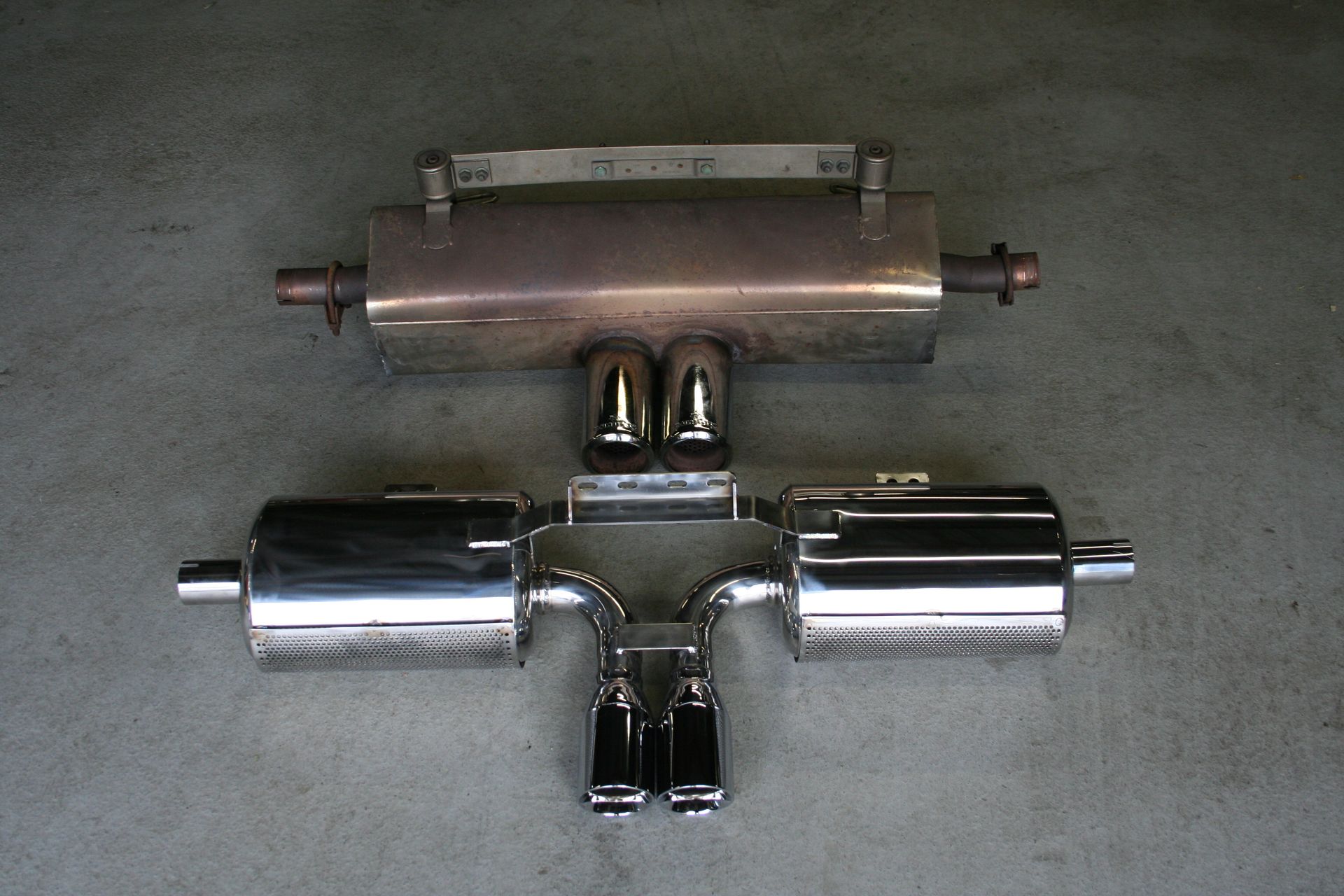 Two exhaust systems: one above is a single unit; the one below is a dual, stainless steel system with four tips. | Autobahn Performance Inc