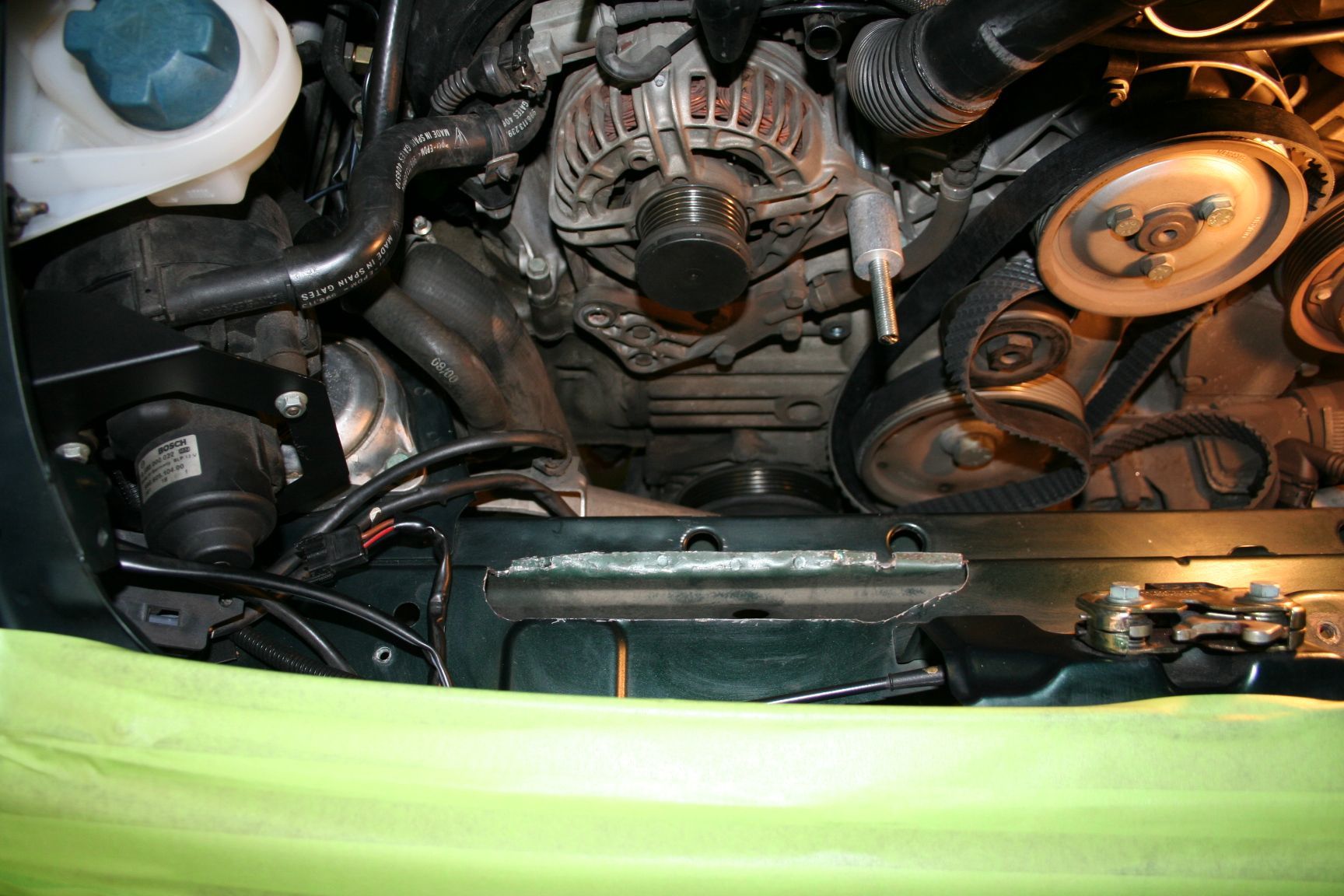 Car engine bay, showing alternator, pulleys, belts, and various engine components. | Autobahn Performance Inc