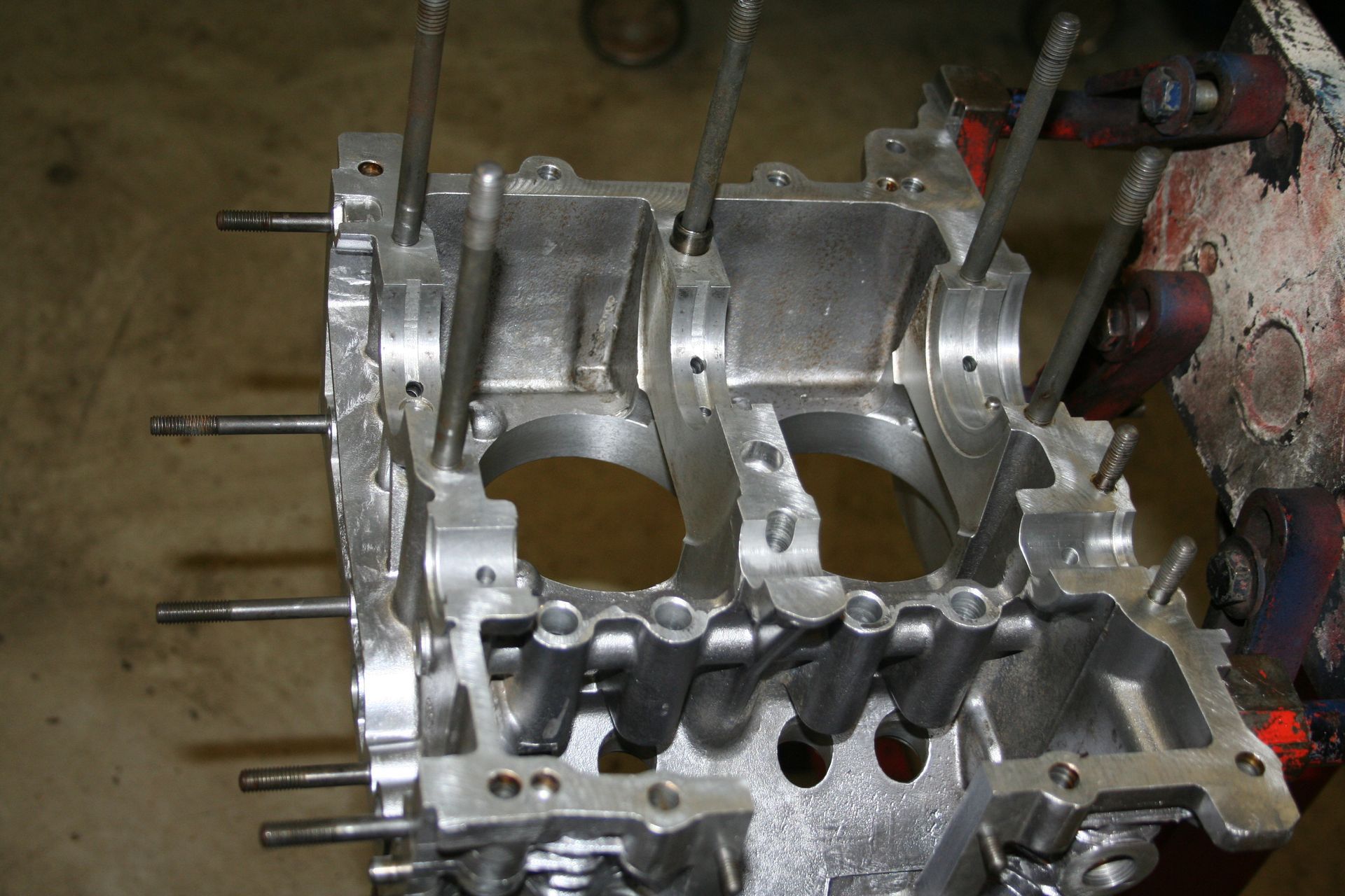 An open engine block with protruding studs, revealing internal components and cylinder cavities. | Autobahn Performance Inc