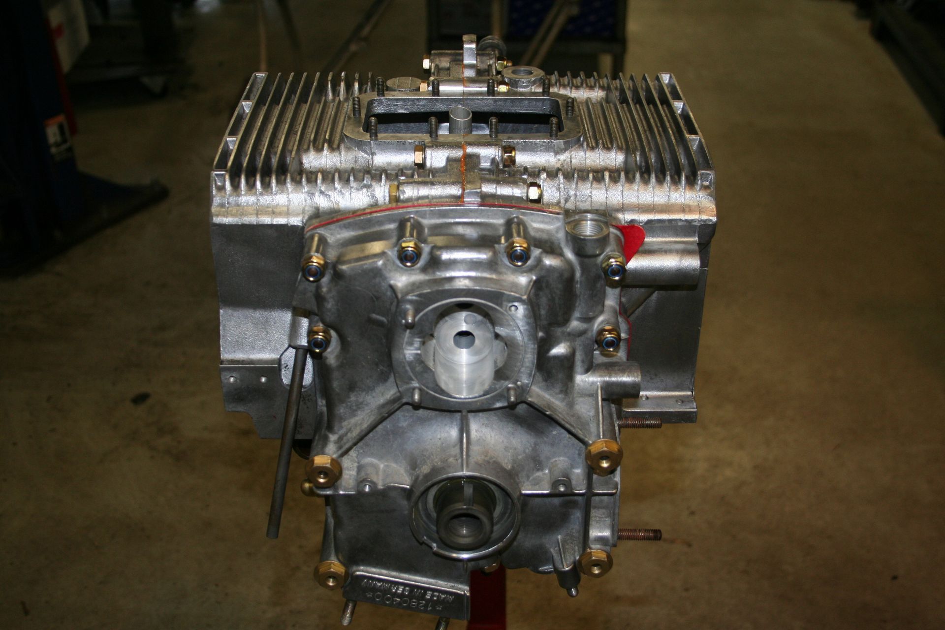 Silver engine, possibly an aircraft engine, viewed from the front. Rectangular with cooling fins on top. | Autobahn Performance Inc