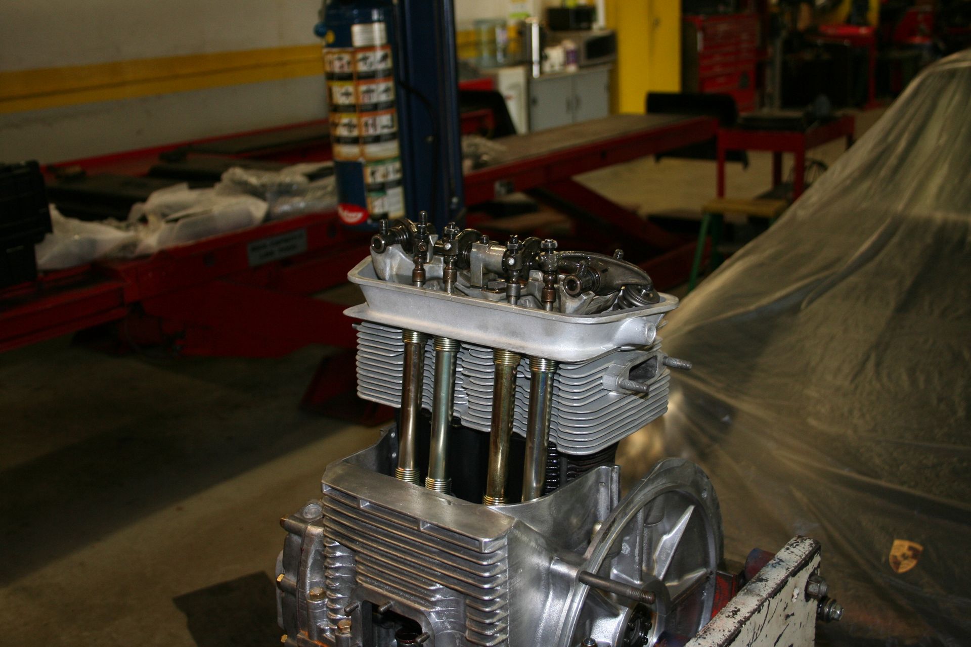 Engine partially disassembled in a garage, showcasing cylinders and valve train. | Autobahn Performance Inc
