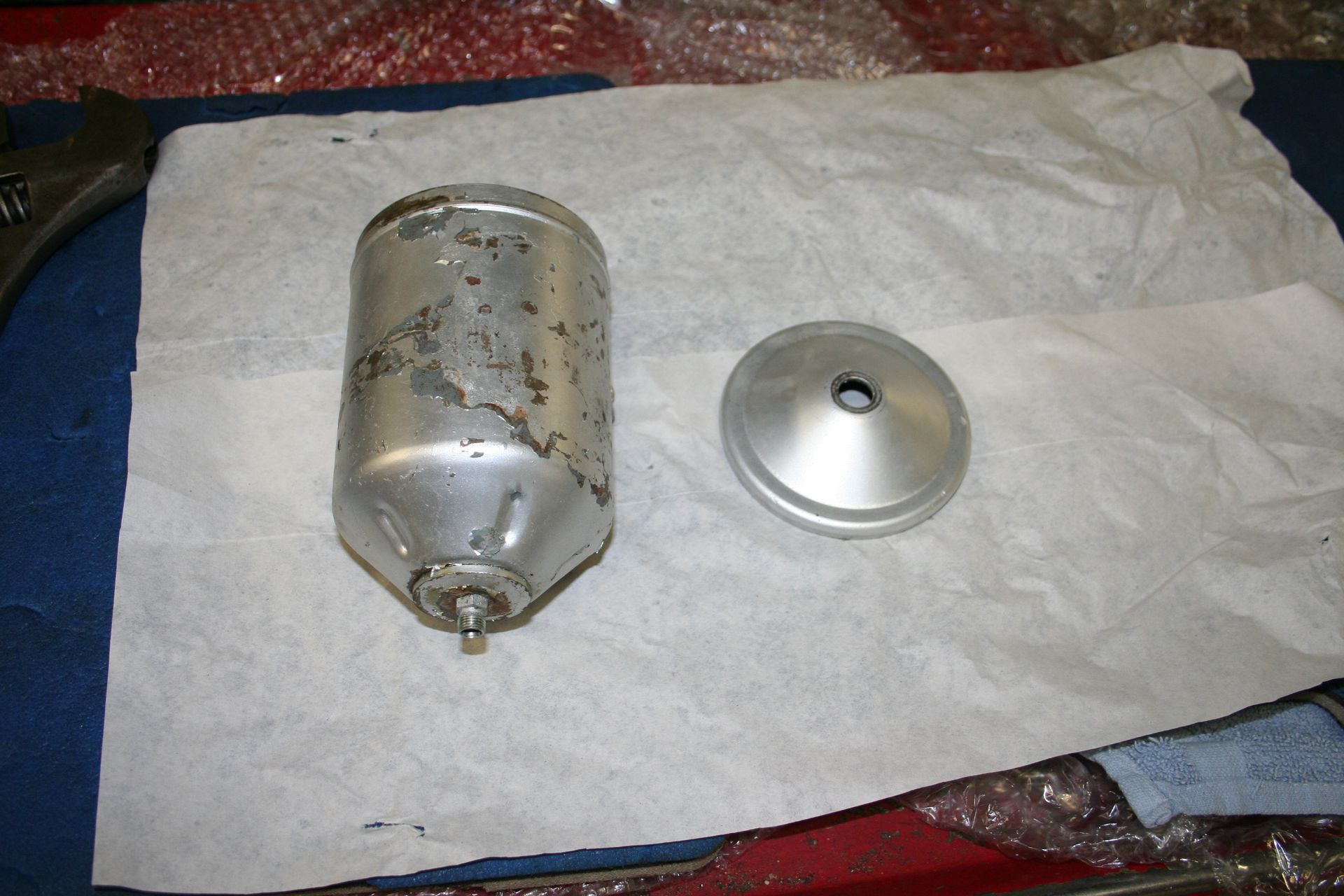 Metal cylindrical component and lid on white paper. | Autobahn Performance Inc