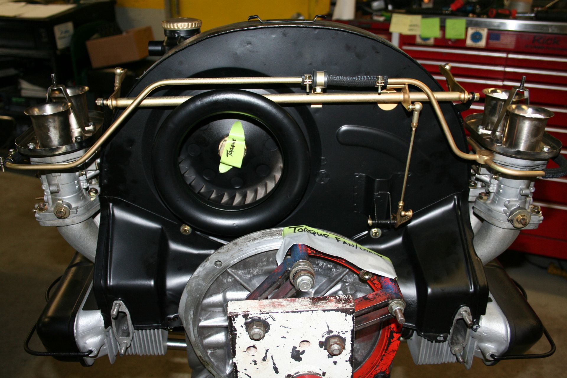 Black Volkswagen engine with dual carburetors, brass fuel lines, and fan shroud. | Autobahn Performance Inc