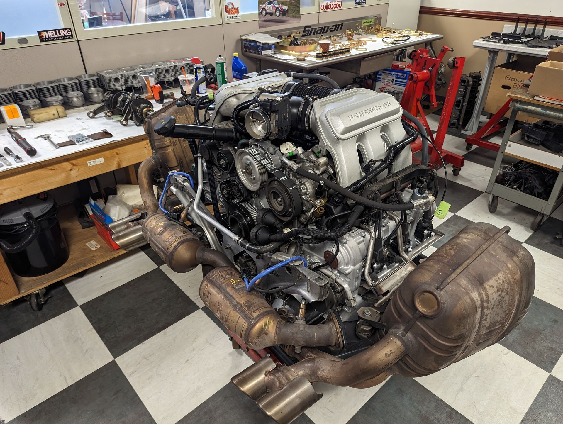Engine assembly with exhaust system in a shop. | Autobahn Performance