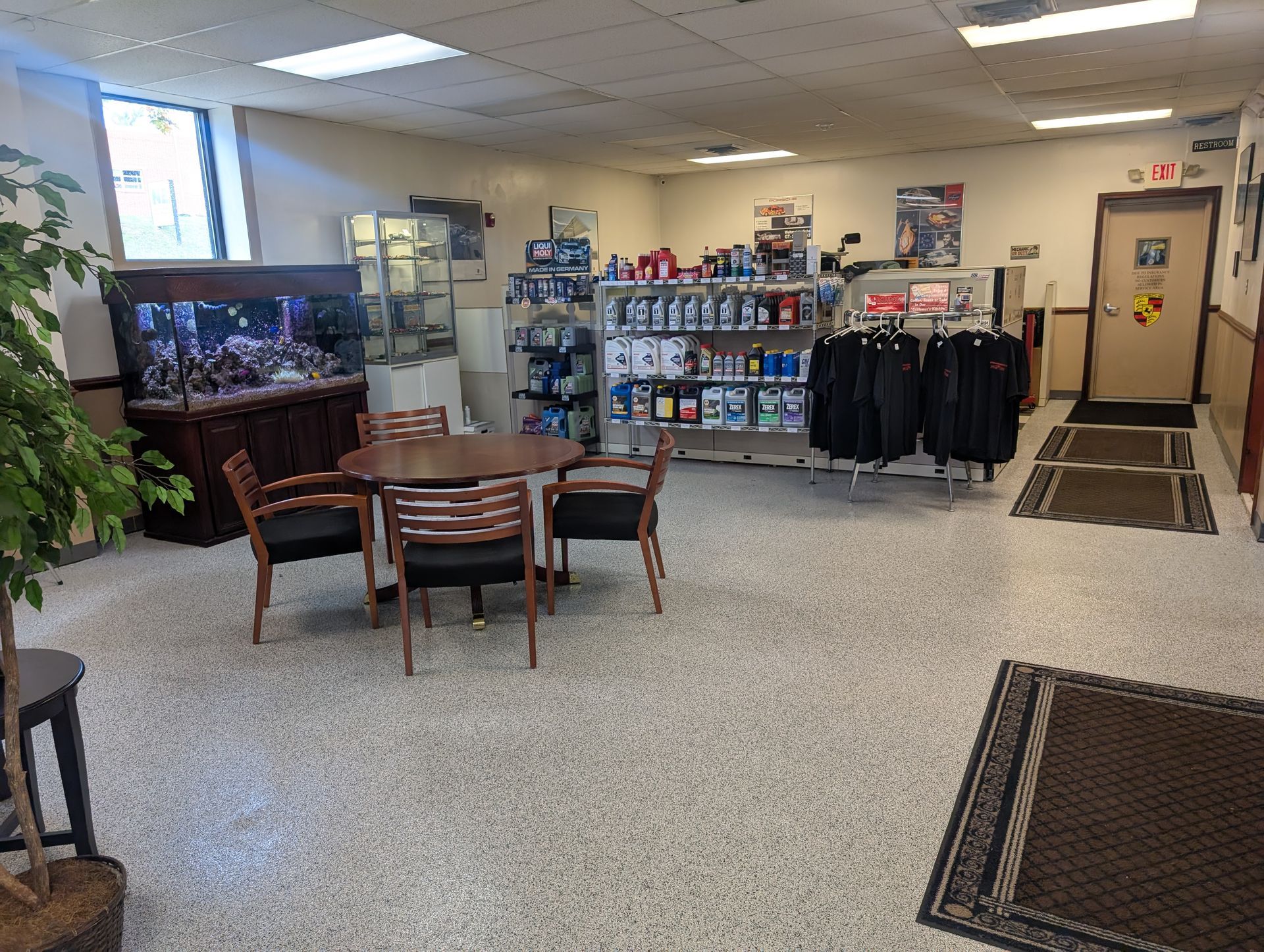 Interior of a store, with aquarium, table, shelves of products, and clothing rack. | Autobahn Performance