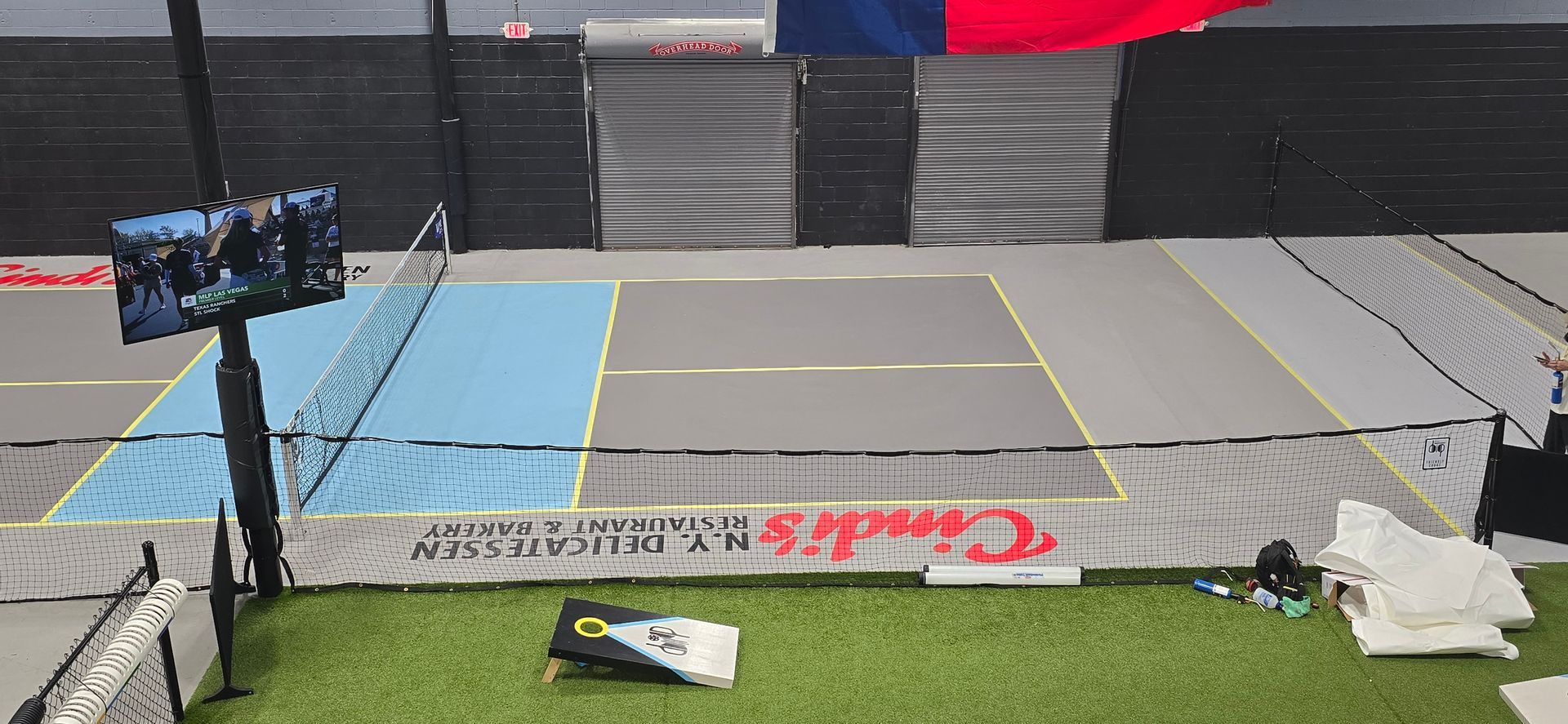 A tennis court with a banner that says chuck 's on it